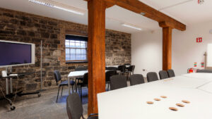 Stonework walls and exposed beams in the Rainsford Room at The Digital Exchange